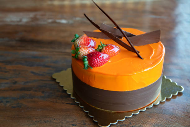 istock Orange cake with strawberries on Wooden table. 1191735490