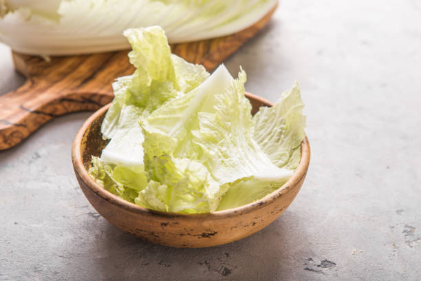 istock Peking fresh chinese cabbages in wood bowl on a white background. top view 1191736621