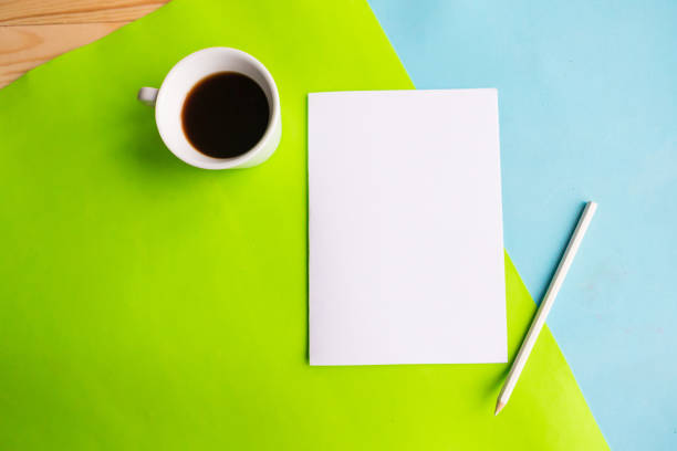 istock White mockup blank and coffee cup on geometric blue and green background. Flat lay, top view, copy space 1191740898