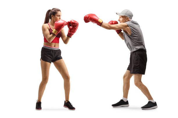 istock Senior man and a young woman training box 1191741904