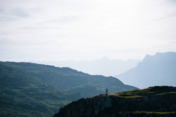 istock Female hiker walks along footpath on mountain ridge 1191742985