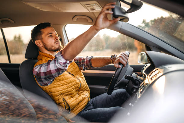 istock Man adjusting a rearview mirror in the car 1191743312