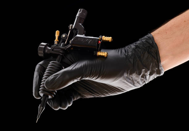 istock Tattoo machine in artist's hand 1191745380
