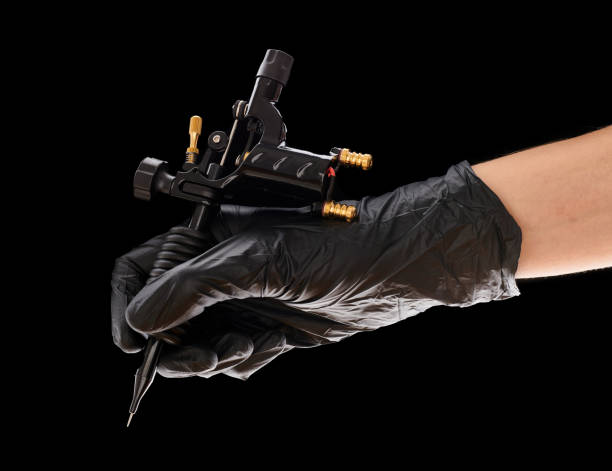 istock Tattoo machine in artist's hand 1191745391