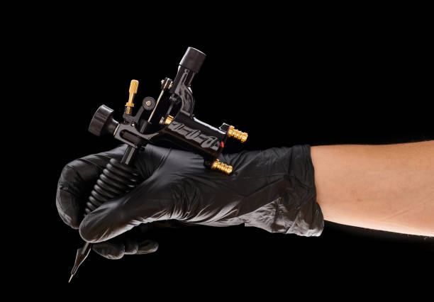 istock Tattoo machine in artist's hand 1191745408