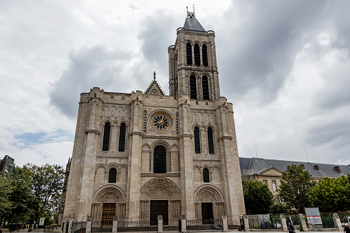 The Basilica of Saint-Denis is a large medieval abbey church in the city of Saint-Denis, now a northern suburb of Paris. The building is of singular importance historically and architecturally as its choir, completed in 1144, shows the first use of all of the elements of Gothic architecture.