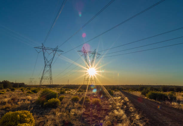Silhouette High voltage electric towers at sunset time. High-voltage power lines. Electricity distribution station