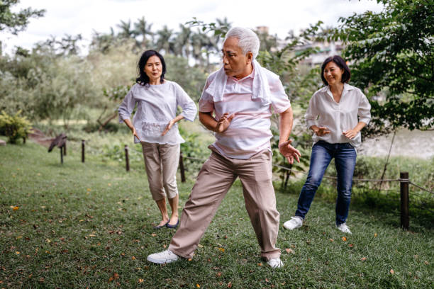 istock Group of people practicing Tai Chi in public park 1191749883