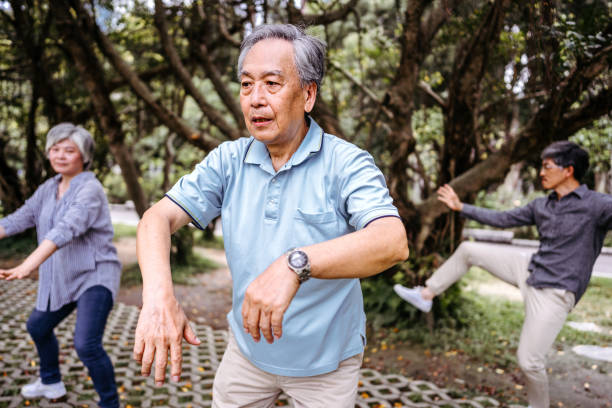 istock Group of people practicing Tai Chi in public park 1191749944