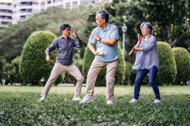 istock Group of seniors taking tai chi class 1191749990