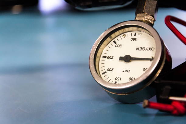Gas pressure indicator, scuba diving oxygen lying on blue table background, copy space