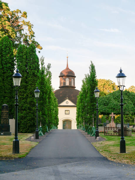 Chapel in Jönköping cemetery, Sweeden, The alley to the East Chapel in the city cemetery, Småland, Sweden in the sunny summer evening. jonkoping stock pictures, royalty-free photos & images