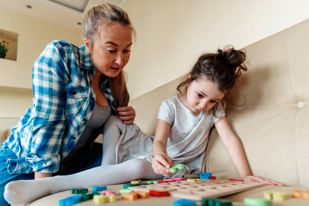 istock A Little Girl is Learning Alphabet with her Mother 1191757695