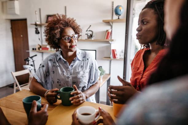 istock Gossip time between African female friends on coffee break 1191758542