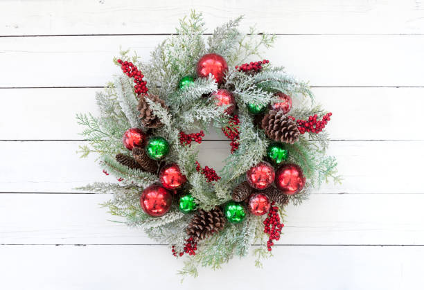 istock Christmas Wreath on an old White Wood Background 1191758907