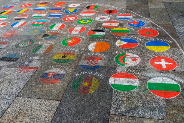 Emblems, national flags of different countries painted on the pavement with multicolored crayons.