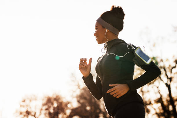 istock Happy black sportswoman jogging while exercising in nature. 1191761032
