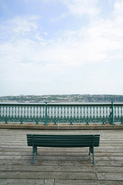 Bench on boardwalk overlooking St Lawrence River in Quebec City.