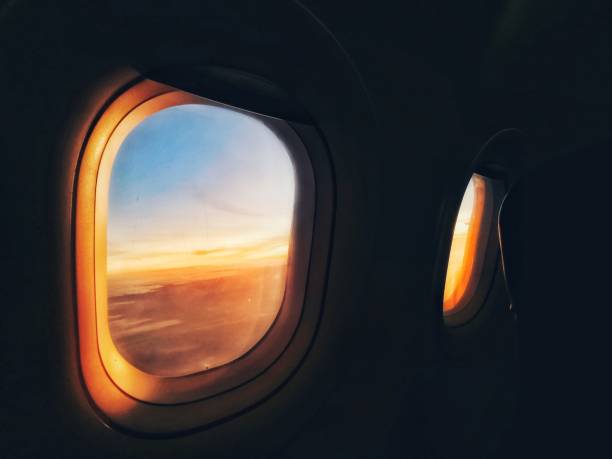 Windows of the white airplane with emergency sign.