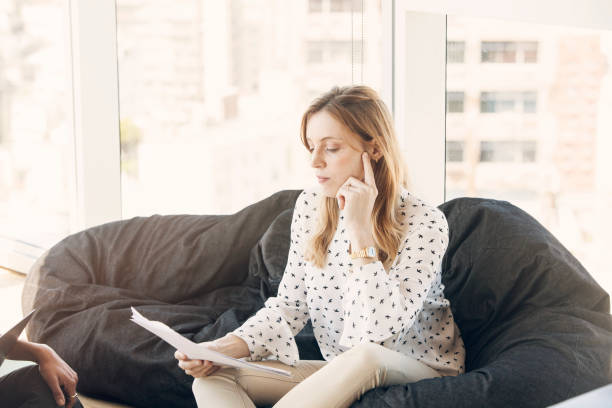 istock Young pensive woman working in the office 1191764490