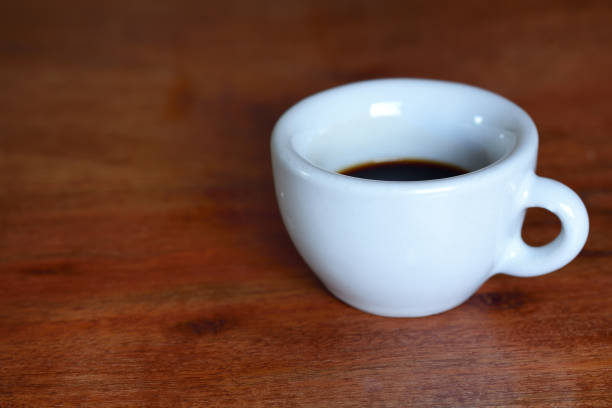 istock A white old cup for espresso stands with coffee on a wooden table 1191765378
