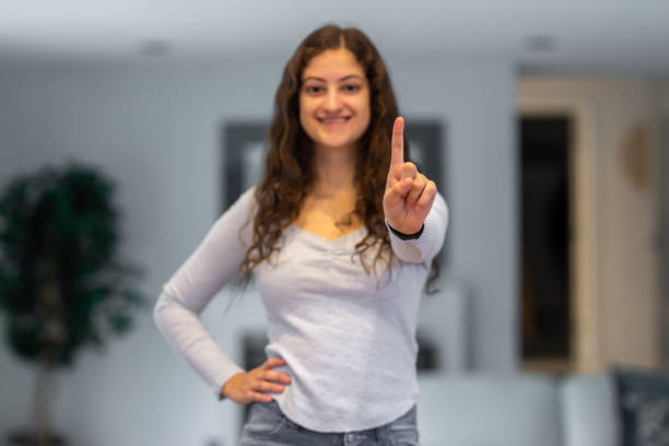 istock teenagers making number 1 with their finger 1191766017