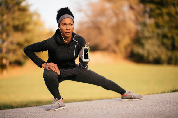 istock Black female athlete stretching her legs while practicing in nature. 1191766263