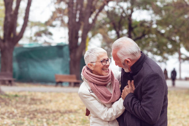 istock Happy Elder Couple Love Relaxing In Park 1191768733