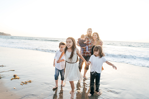 Shot of a happy young family having fun at the beach