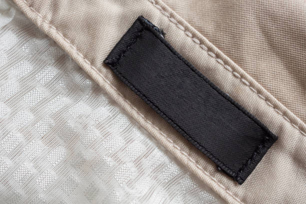 istock Blank black laundry care clothing label on fabric texture 1191769964