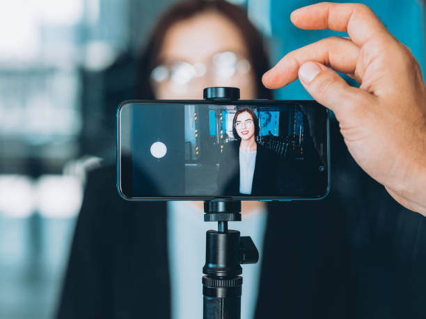 business coaching successful woman interview Business coaching. Professional video blog. Male assistant recording successful woman interview. tripod stock pictures, royalty-free photos & images