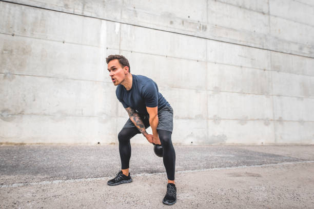 istock Strong Young Male Athlete Working Out with Kettlebell 1191770059