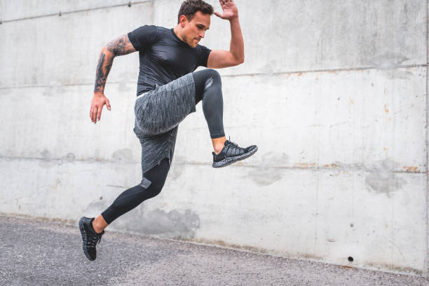istock Caucasian Male Athlete Sprinting Outdoors at Full Extension 1191770081