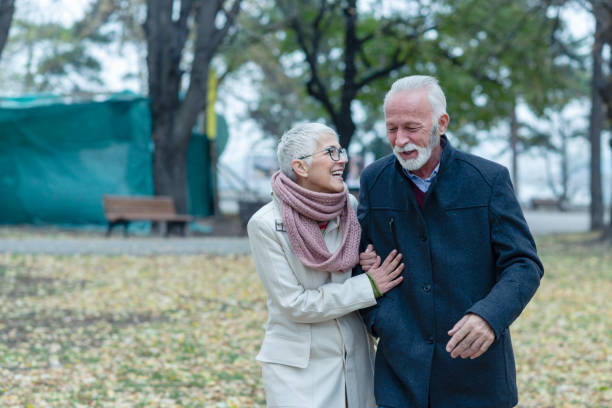 istock Happy Elder Couple Love Relaxing In Park 1191770254