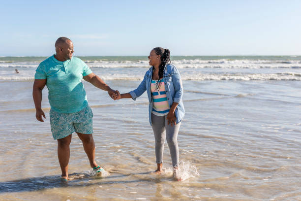 istock Middle Aged African Couple on the Beach Together 1191779997
