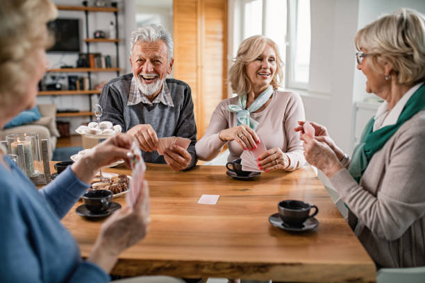 istock Cheerful senior people playing cards and communicating at home. 1191780301