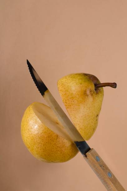 istock knife slicing a yellow pear in the air 1191787123