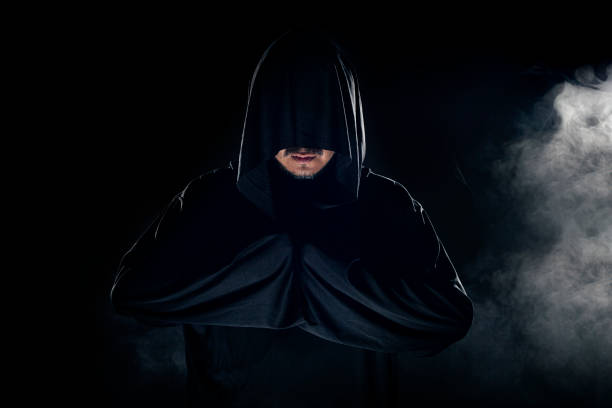 istock Cult Leader Wearing a Dark Robe with Smoky Background 1191790246
