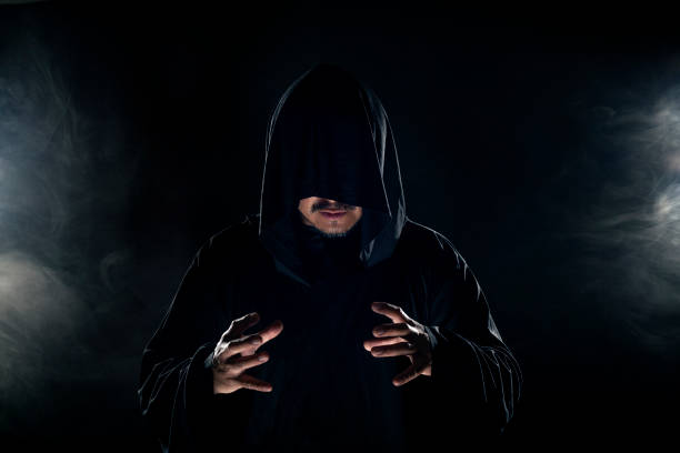 istock Cult Leader Wearing a Dark Robe with Smoky Background 1191790252