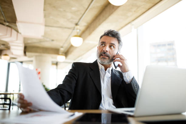 istock Businessman solving problems on the phone in the office 1191790393