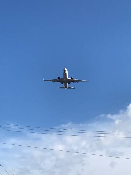 istock Looking up at a landing plane 1191791504