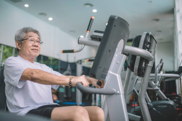 istock an asian chinese active senior sitting on exercise equipment workout cardio 1191793229