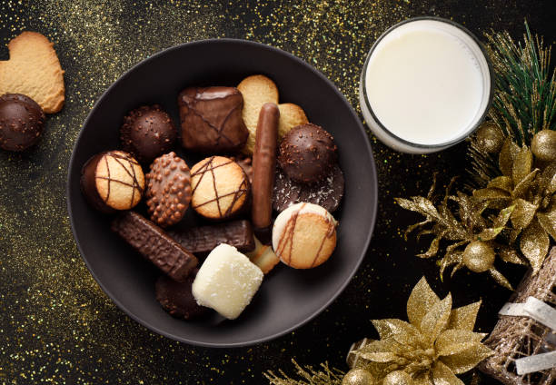 Fancy chocolate cookies and milk Fancy chocolate cookies and a glass of milk for Christmas chocolate cookies stock pictures, royalty-free photos & images