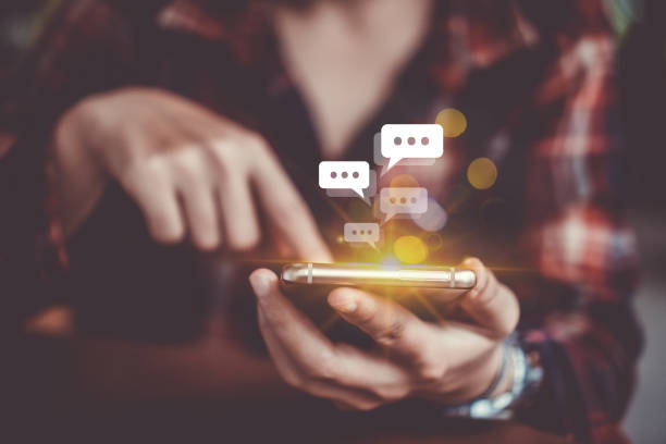 istock Women hand using smartphone typing, chatting conversation in chat box icons pop up. Social media maketing technology concept.Vintage soft color tone background. 1191798462