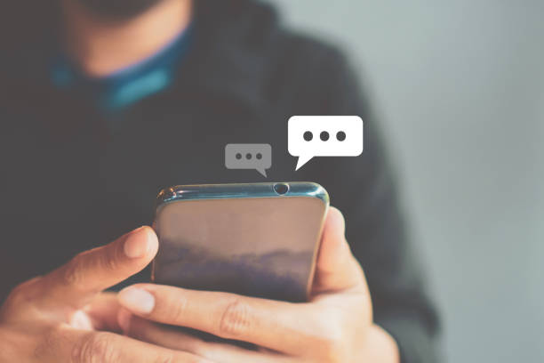 istock Women hand using smartphone typing, chatting conversation in chat box icons pop up. Social media maketing technology concept.Vintage soft color tone background. 1191798980