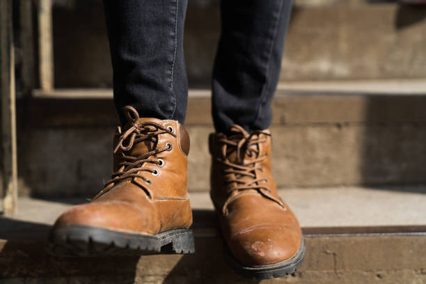 istock A man's feet in boots steps down a staircase 1191800149