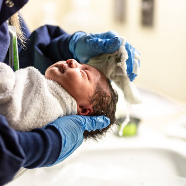 istock Newborn Hispanic Baby First Bath at Hospital 1191802878