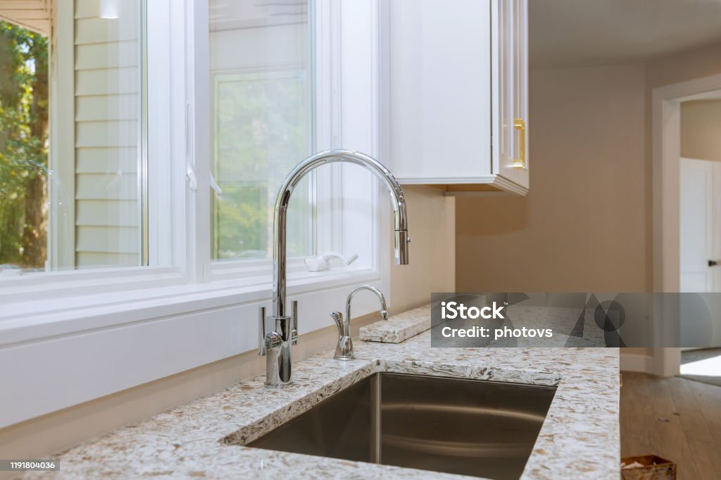 New classic kitchen in modern style a new sink in kitchen New classic kitchen in modern style a new ceramic sink in kitchen Granite - Rock Stock Photo