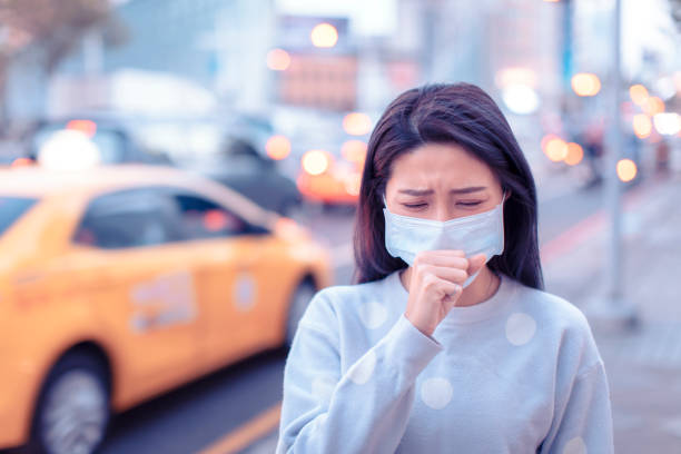 young  woman wear mask in the city during smog day - illness mask pollution car imagens e fotografias de stock