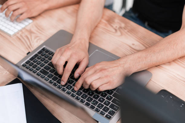 istock close up. guy is a student typing on a laptop 1191805241